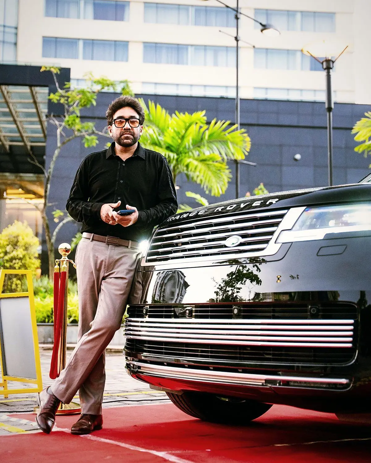 Sabad, founder of Monte Carlo, leaning against a black Range Rover